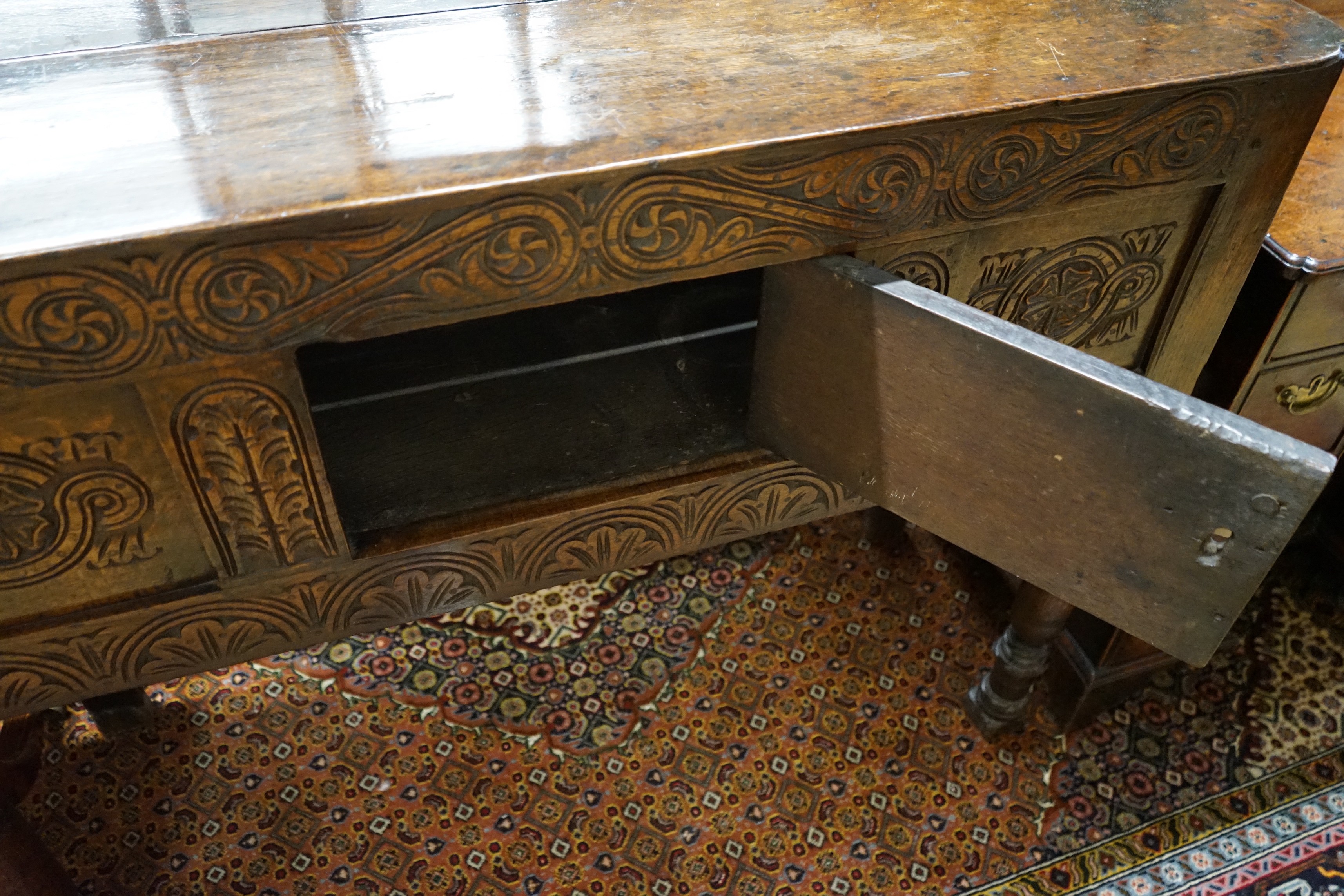 An 18th century and later carved oak cabinet on stand, width 118cm, depth 42cm, height 96cm